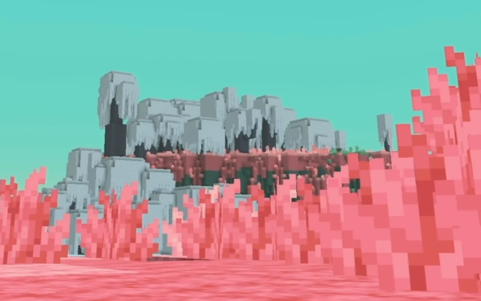 Pale rock formations above pink vegetation